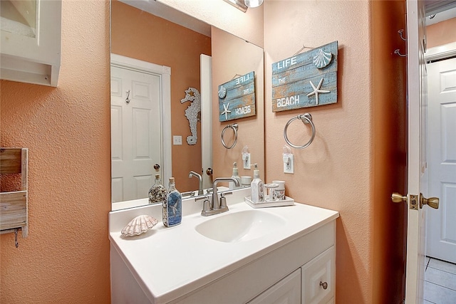 141 Mustang Royale Blvd, Port Aransas, TX 78373 - bathroom with vanity, a textured wall, and tile patterned flooring