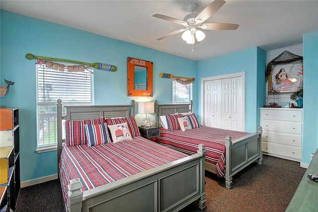 141 Mustang Royale Blvd, Port Aransas, TX 78373 - bedroom featuring a closet, dark carpet, a ceiling fan, and baseboards