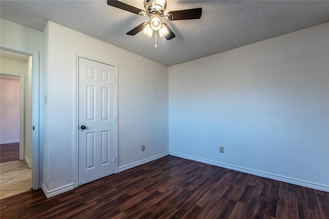 bedroom featuring dark hardwood / wood-style flooring, a closet, a textured ceiling, and an inviting chandelier