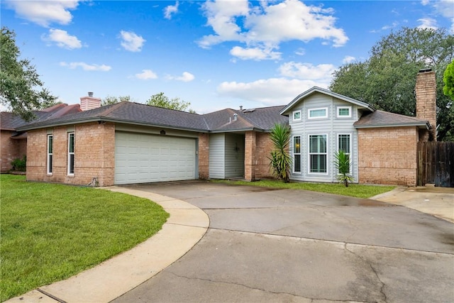 view of front of property with a front yard and a garage