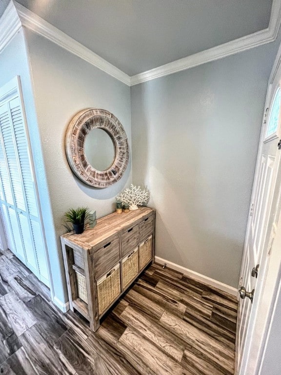 detailed view of wood finished floors, baseboards, and crown molding