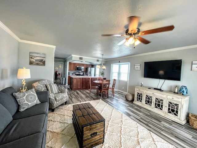 living room featuring crown molding, ceiling fan, light wood-style flooring, a textured ceiling, and baseboards