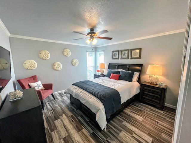 bedroom with ornamental molding, wood finished floors, baseboards, and ceiling fan