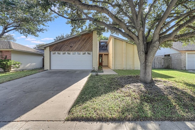 view of front facade with a garage and a front lawn