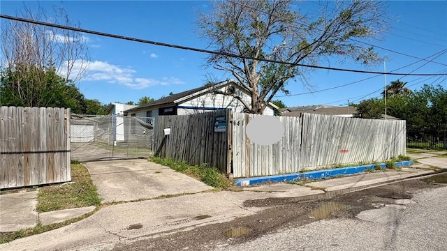 view of side of property with a gate and a fenced front yard