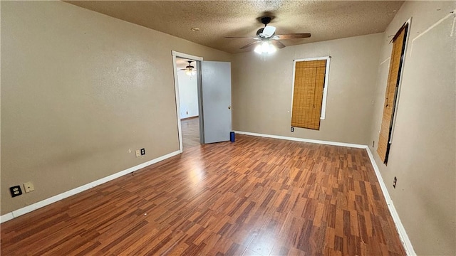 unfurnished bedroom with wood finished floors, a textured ceiling, baseboards, and a ceiling fan