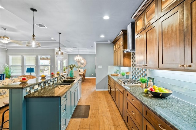 2718 Yeager Dr, Corpus Christi, TX 78410 - kitchen featuring wall chimney range hood, appliances with stainless steel finishes, a kitchen breakfast bar, decorative backsplash, and recessed lighting