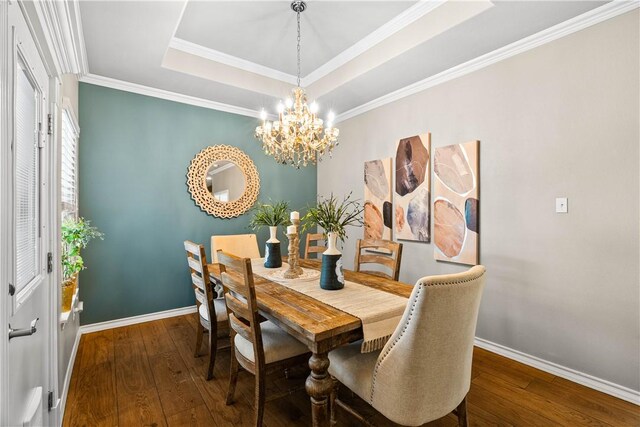 2718 Yeager Dr, Corpus Christi, TX 78410 - dining area featuring hardwood / wood-style flooring, a chandelier, a tray ceiling, and ornamental molding