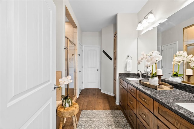 2718 Yeager Dr, Corpus Christi, TX 78410 - bathroom with a shower stall, double vanity, and wood finished floors