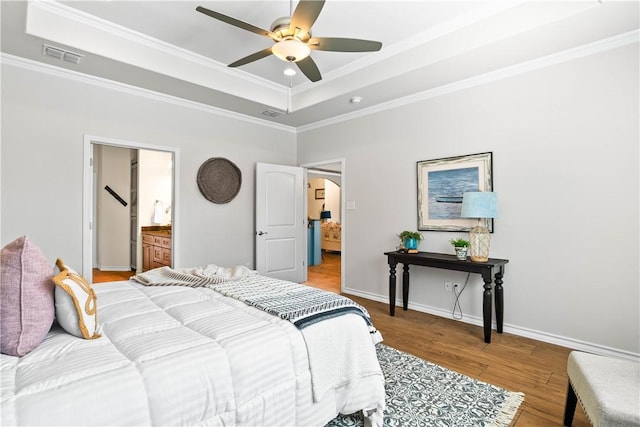 2718 Yeager Dr, Corpus Christi, TX 78410 - bedroom with light wood-type flooring, a raised ceiling, crown molding, arched walkways, and a ceiling fan