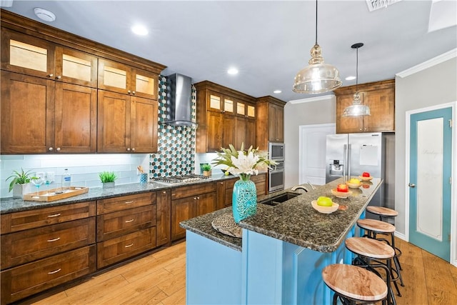 2718 Yeager Dr, Corpus Christi, TX 78410 - kitchen with wall chimney exhaust hood, ornamental molding, backsplash, light wood-style flooring, and pendant lighting