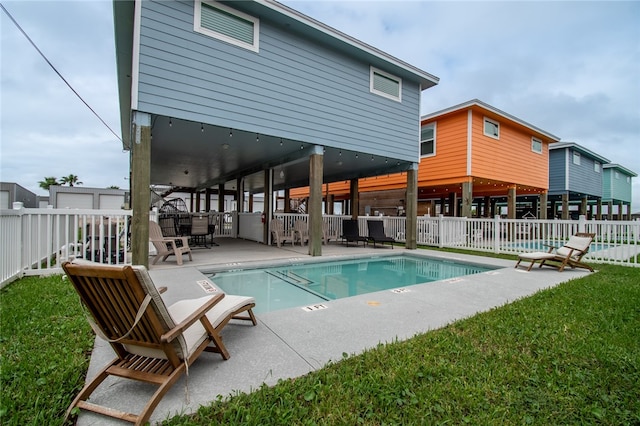 view of pool with a yard and a patio area