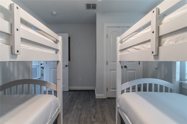 bedroom featuring dark hardwood / wood-style flooring and a closet