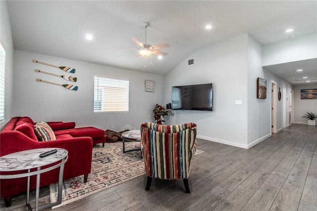 living room with lofted ceiling, hardwood / wood-style flooring, and ceiling fan