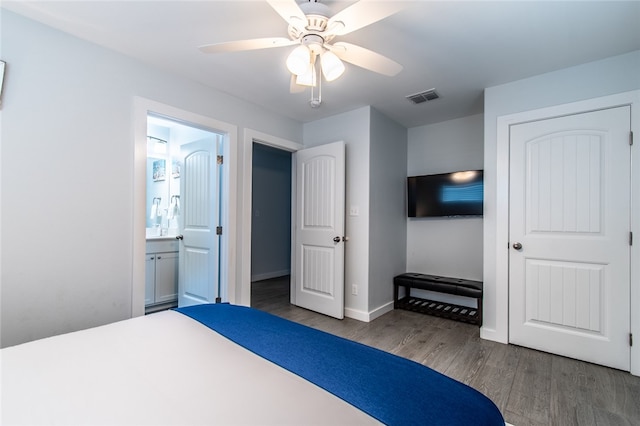 bedroom featuring dark wood-type flooring, ceiling fan, and ensuite bath