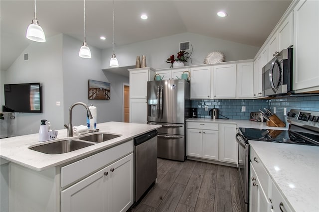 kitchen with a center island with sink, stainless steel appliances, dark hardwood / wood-style flooring, pendant lighting, and sink