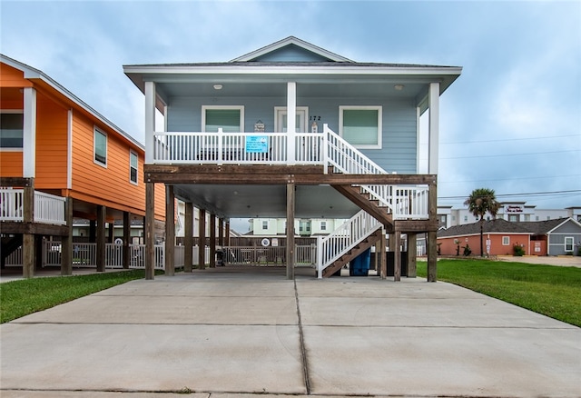 view of front of home with covered porch and a carport