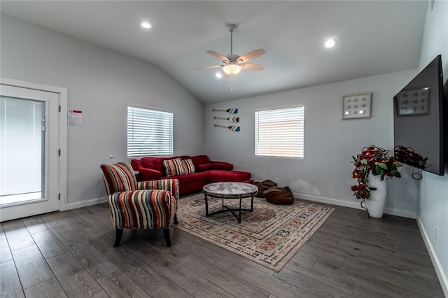 living room with dark wood-type flooring, a wealth of natural light, ceiling fan, and vaulted ceiling