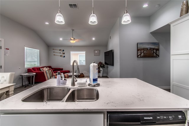 kitchen featuring pendant lighting, a wealth of natural light, lofted ceiling, and an island with sink