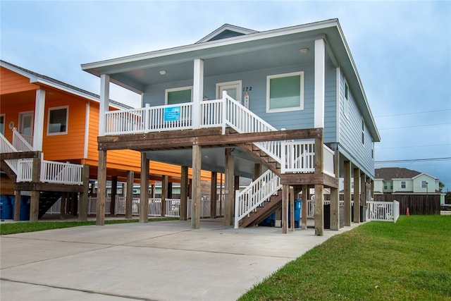 back of property featuring a porch, a yard, and a carport