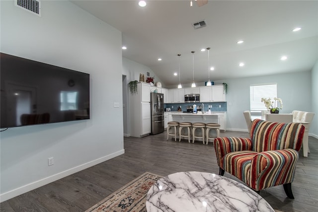 living room featuring dark wood-type flooring and lofted ceiling