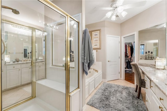 5030 S Oso Pkwy, Corpus Christi, TX 78413 - bathroom featuring vanity, a shower stall, a bath, a ceiling fan, and a spacious closet