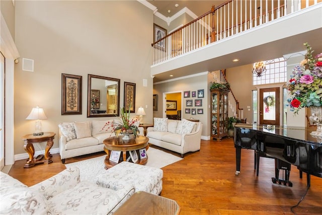5030 S Oso Pkwy, Corpus Christi, TX 78413 - living room featuring a high ceiling, crown molding, wood finished floors, and stairs
