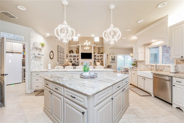 5030 S Oso Pkwy, Corpus Christi, TX 78413 - kitchen featuring dishwasher, a chandelier, a kitchen island, tasteful backsplash, and light tile patterned floors