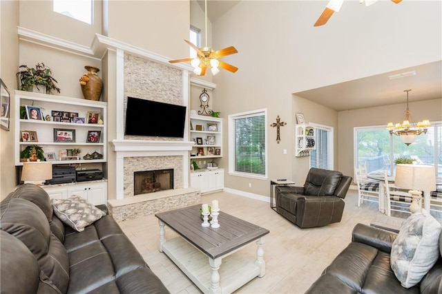 5030 S Oso Pkwy, Corpus Christi, TX 78413 - living area with ceiling fan, a chandelier, a high ceiling, a fireplace, and built in features