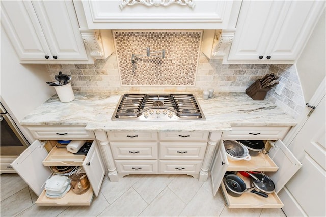 5030 S Oso Pkwy, Corpus Christi, TX 78413 - kitchen featuring stainless steel gas cooktop, white cabinets, light tile patterned floors, and light stone counters