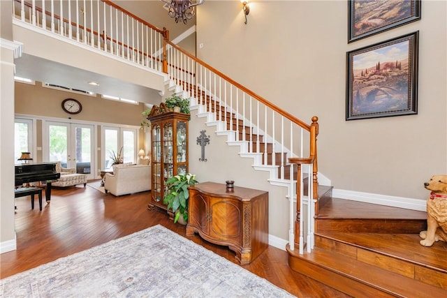 5030 S Oso Pkwy, Corpus Christi, TX 78413 - stairs featuring wood finished floors, a high ceiling, a chandelier, and french doors