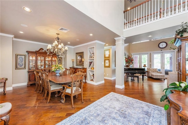 5030 S Oso Pkwy, Corpus Christi, TX 78413 - dining area featuring wood finished floors, ornamental molding, ornate columns, recessed lighting, and a chandelier