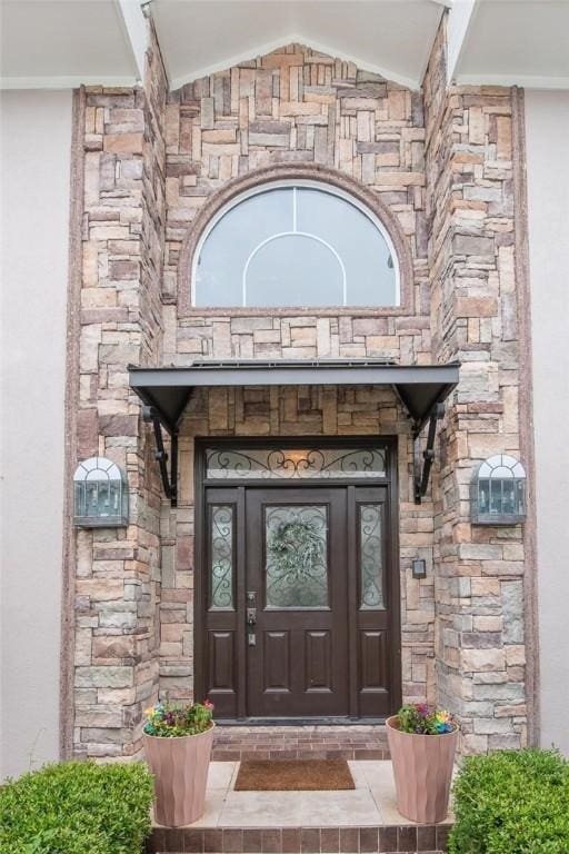 8018 Saint Laurent Dr, Corpus Christi, TX 78414 - doorway to property featuring stone siding, stucco siding, and french doors