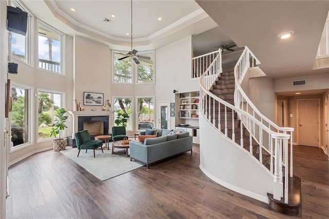 8018 Saint Laurent Dr, Corpus Christi, TX 78414 - living area with a ceiling fan, stairs, wood finished floors, a towering ceiling, and a fireplace
