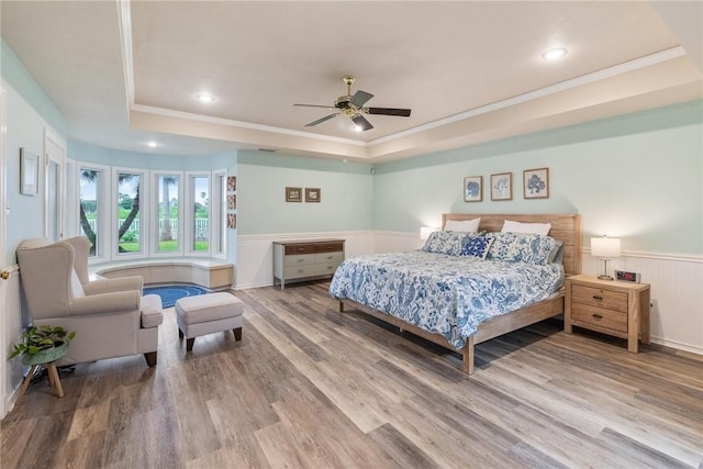 8018 Saint Laurent Dr, Corpus Christi, TX 78414 - bedroom with a raised ceiling, ornamental molding, wood finished floors, a wainscoted wall, and a ceiling fan