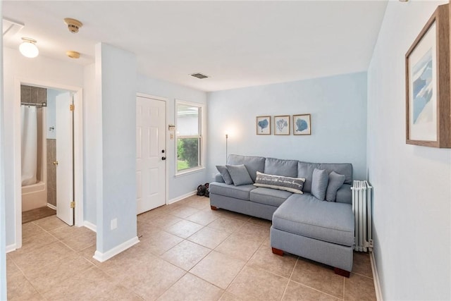8018 Saint Laurent Dr, Corpus Christi, TX 78414 - living area with radiator, light tile patterned flooring, and baseboards