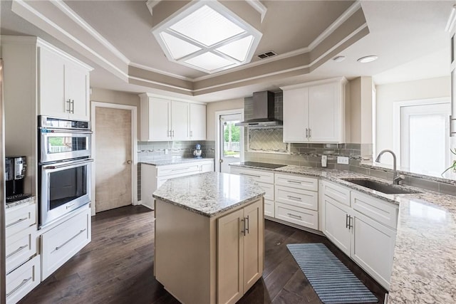 8018 Saint Laurent Dr, Corpus Christi, TX 78414 - kitchen featuring wall chimney range hood, a sink, a raised ceiling, double oven, and black electric cooktop