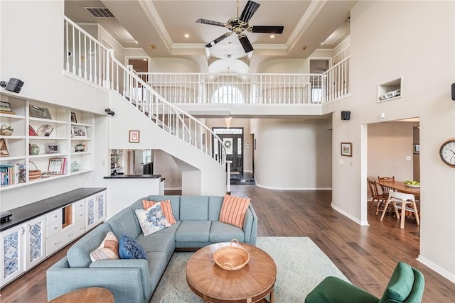 8018 Saint Laurent Dr, Corpus Christi, TX 78414 - living area featuring stairway, ceiling fan, wood finished floors, ornamental molding, and a towering ceiling
