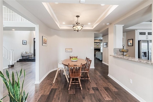 8018 Saint Laurent Dr, Corpus Christi, TX 78414 - dining area with a tray ceiling, stairs, recessed lighting, dark wood finished floors, and baseboards