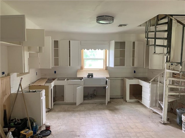 kitchen featuring sink and white cabinets