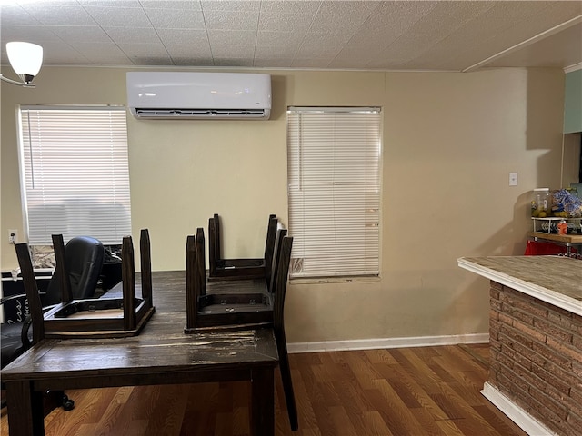 dining space featuring a wall unit AC and dark hardwood / wood-style floors