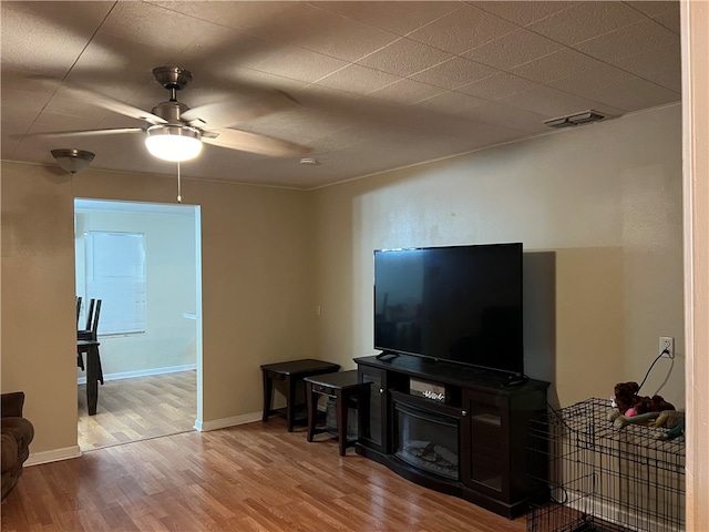 living room with hardwood / wood-style floors and ceiling fan