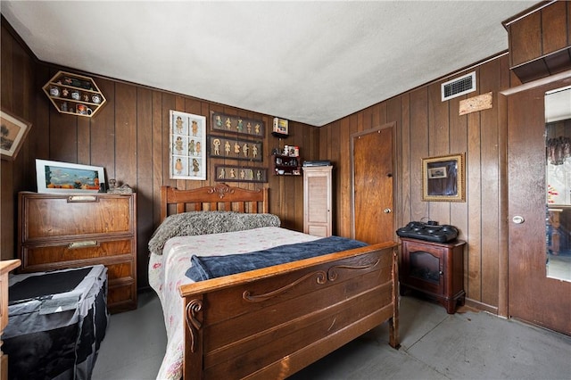 bedroom with wood walls