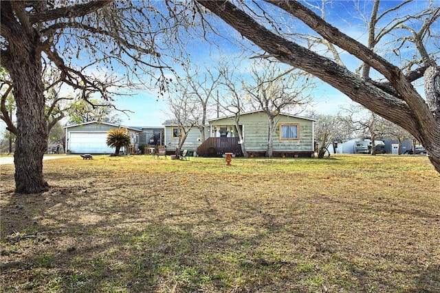 single story home featuring a garage and a front yard