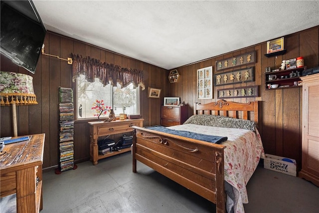 bedroom with concrete floors and wood walls