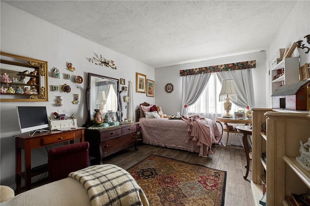 bedroom featuring hardwood / wood-style floors and a textured ceiling