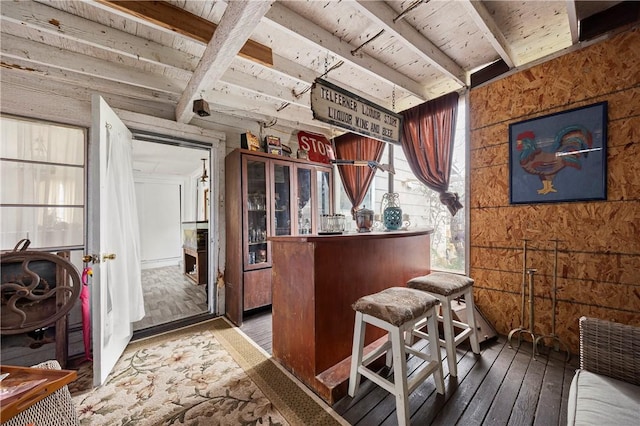 interior space with hardwood / wood-style flooring, beamed ceiling, and wood ceiling