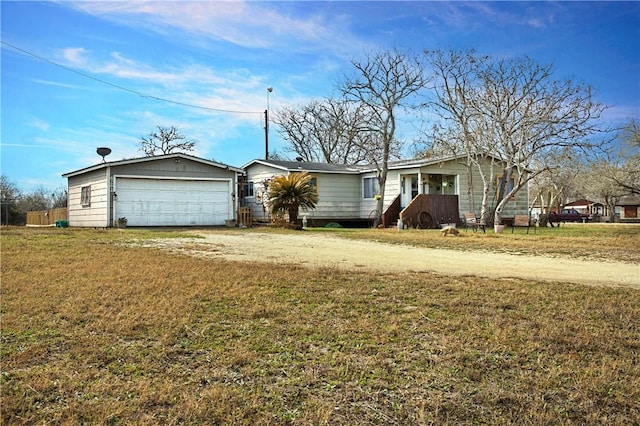 ranch-style home featuring a garage and a front lawn