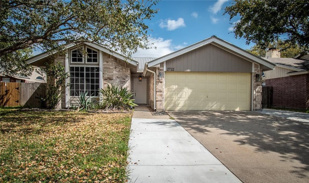 ranch-style home with a front yard and a garage