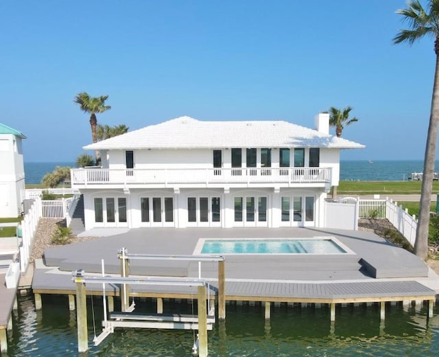 1895 Bay Shore Dr, Rockport, TX 78382 - rear view of property featuring a water view, a patio area, a balcony, french doors, and a fenced in pool